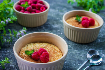 Cheese soufflé with raspberries on a dark background, close-up, simple composition