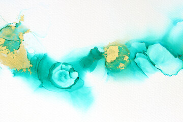 art photography of abstract fluid painting with alcohol ink, blue turquoise and gold colors. Paper texture