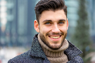 portrait of an handsome man smiling, looking at the camera, blue eyes