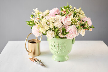 Beautiful flower arrangement in a green ceramic vase. Flowers bunch, set for interior. Fresh cut flowers for decoration home. European floral shop. Delivery fresh cut flower.v