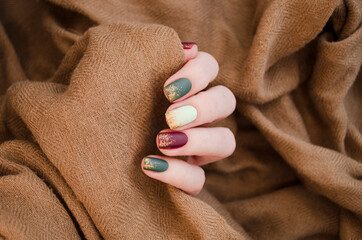 Beautiful matte muted color nails close-up, glittery nail art manicure.