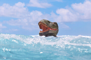 Man with dinosaur mask in sea on sunny day