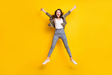 Fototapeta na wymiar Full length photo of adorable cute young woman dressed brown shirt jumping high like star isolated yellow color background