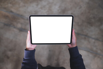 Top view mockup image of a woman holding digital tablet with blank white desktop screen