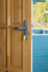 open door with key in lock, door handle