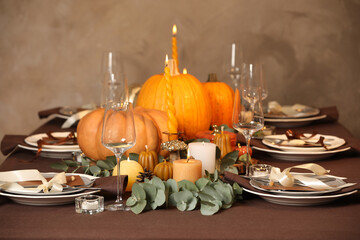 Beautiful autumn place setting and decor on table in room