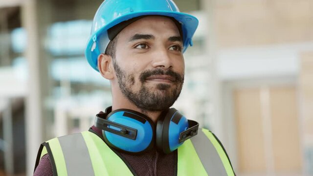 Happy mixed race construction site worker looking at camera