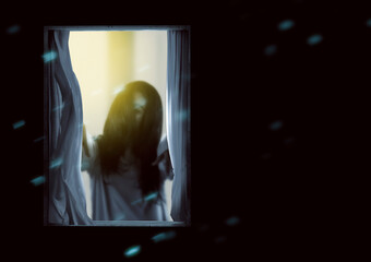 Scary ghost woman standing on the window