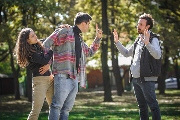 Two aggressive men in quarrel and woman. Finger pointing