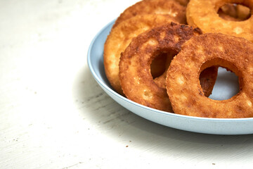Fried curd donuts in a blue plate