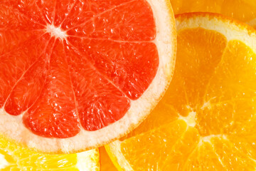 Fresh juicy grapefruit and orange slices closeup top view. Tropical citrus fruits texture...