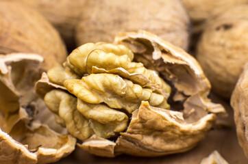 Crushed Walnut on the wood background. Close up.