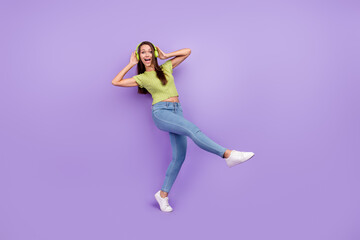 Full length body size view of pretty carefree cheerful girl listening rock dancing having fun isolated over purple violet color background
