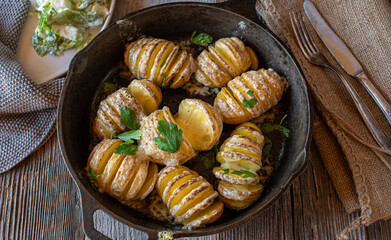 Hasselback  potatoes with butter and cheese. 