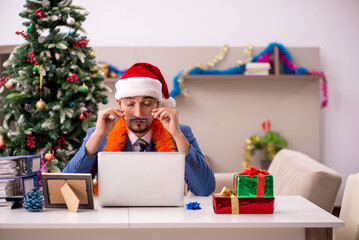 Young businessman working from home at Christmas eve
