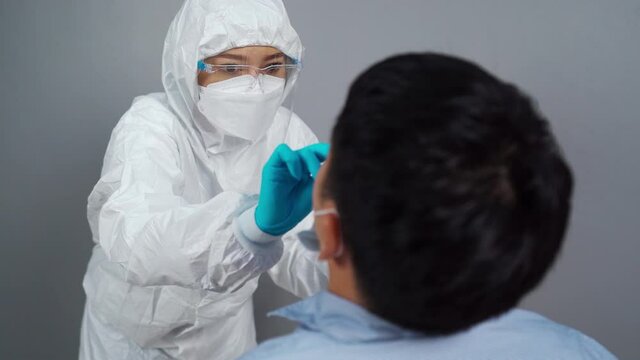 doctor with PPE suit test coronavirus(covid-19) to patient by nasal swab
