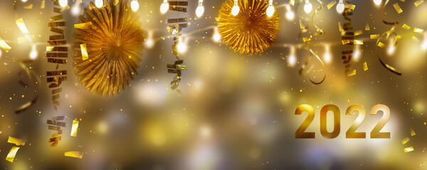 beautiful golden party decoration with 2022 on blurred shiny background, cheerful backdrop for...