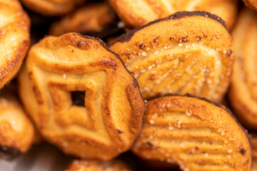 Curly cookies covered with chocolate icing, background image, close-up, selective focus.
