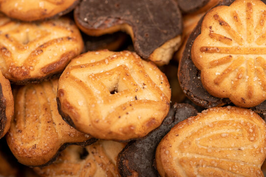 Curly cookies covered with chocolate icing, background image, close-up, selective focus.