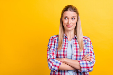 Photo of interested blond ceo lady crossed arms look empty space wear blue shirt isolated on yellow color background