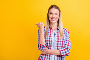 Photo of funky blond hr lady point empty space wear blue shirt isolated on yellow color background