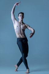 Obraz premium Young and graceful male ballet dancer isolated on old navy studio background. Art, motion, action, flexibility, inspiration concept.