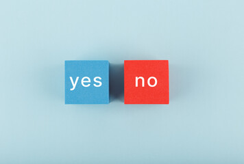Yes and no written on blue and red toy cubes. Concept of positive and negative answer
