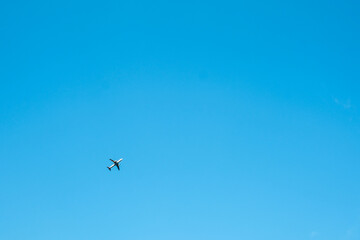 Big airplane in air on blue sky, View of flying airplane from bottom from ground