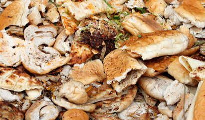 pieces of bread wasted in the dump