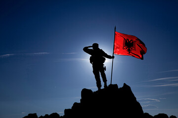 unrecognizable soldier with the Albanian flag
