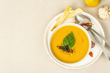 Pumpkin cream soup. Traditional autumn food. Hot dish, ripe vegetables, fragrant spices