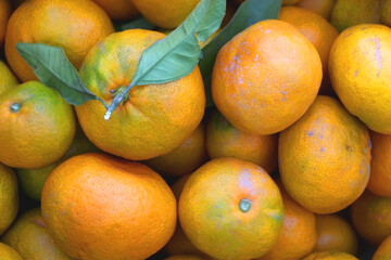 Wooden crate filled with fresh tangerines. Top view.