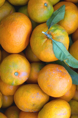 Wooden crate filled with fresh tangerines. Top view.