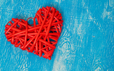 Red wicker heart on a wooden blue background. Valentine's Day. Place for text