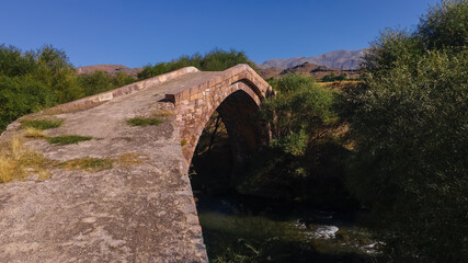 Fototapeta na wymiar Old Bridge Dadal beside Agarakadzor in Armenia, Aerial View