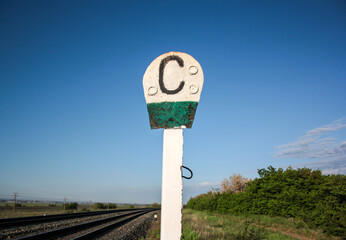 A sign about the whistle blowing on the railway tracks outside the city. Railway sign on the...
