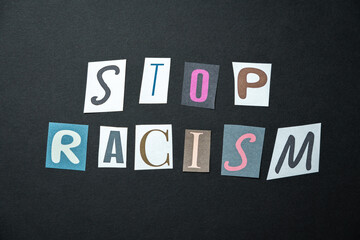 Stop racism words. Caption, heading made of letters with different fonts on a dark background.