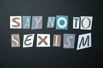 Say no to sexism words. Caption, heading made of letters with different fonts on a dark background.