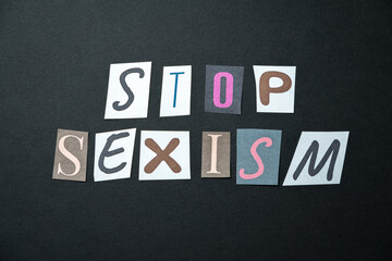 Stop sexism words. Caption, heading made of letters with different fonts on a dark background.