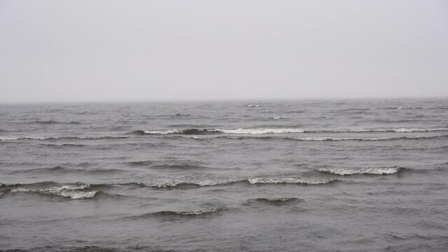  Sea in cloudy weather background. Gray sky and water on a gloomy sea coast landscape.
