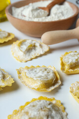 Concept of cooking ravioli on white background
