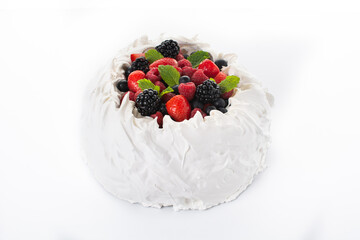 Delicious Pavlova cake with meringue topped and fresh berries isolated on white background	