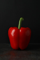 Red bell pepper on dark table, close up