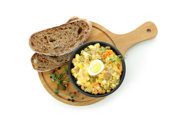 Board with Olivier salad, bread and spices isolated on white background