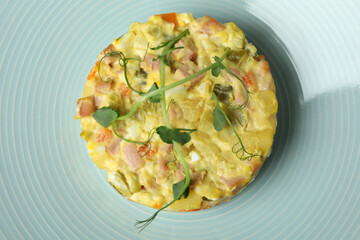Plate with Olivier salad all over background, close up