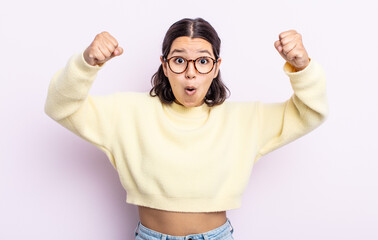 pretty teenager woman celebrating an unbelievable success like a winner, looking excited and happy...