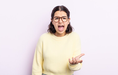 pretty teenager woman looking angry, annoyed and frustrated screaming wtf or what’s wrong with you