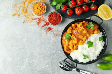 Concept of tasty food with chicken tikka on gray textured background