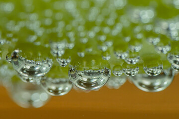 Sparkling water bubbles with mint, with grapes, apples and tomatoes
taken at close range