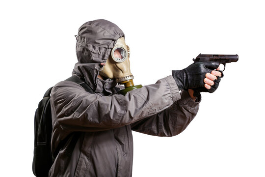 An isolated shot of a man dressed in a gas mask, a hooded jacket, a backpack, gloves, holding a gun in his hands and aiming to the right. On a white isolated background